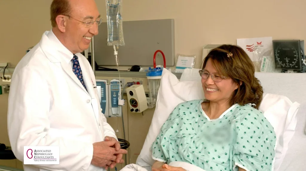 Doctor talking with a smiling patient sitting up in a hospital bed